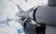 A military rocket pointed into a cloudy sky