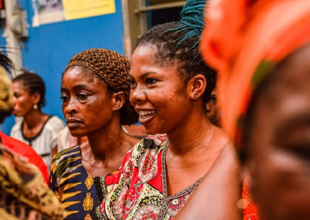 Abuja, Nigeria - January 10, 2023: African sitting While Waiting on a Queue for Medical Care and Attention in a Rural Community.