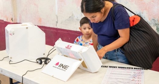  A woman casting her vote for State of Mexico's Governor using a new electronic ballot box system.