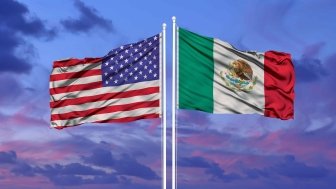 U.S. and Mexican flags at sunset