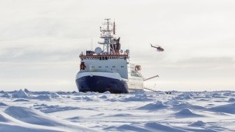 Photo of an icebreaker and helicopter