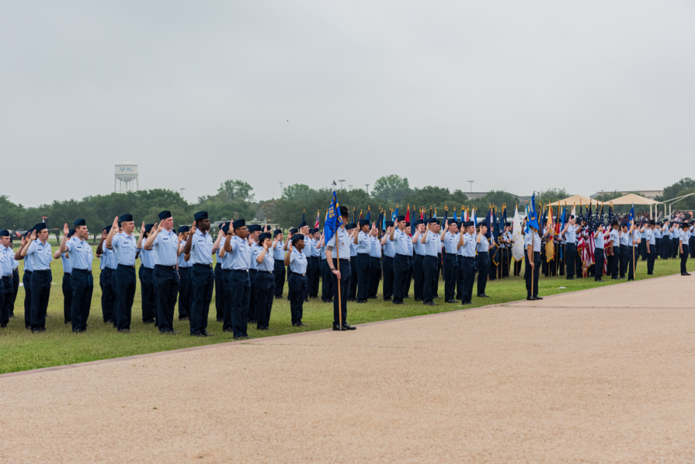 Airmen salute an American flag