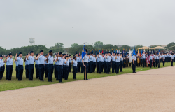 Airmen salute an American flag