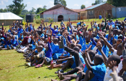 Happy_African_Students_Sitting_and_Raising_Hands