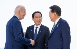 President Biden, Prime Minister Kishida, and President Yoon speaking casually at an event.