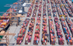 Aerial view of shipping container port with cranes