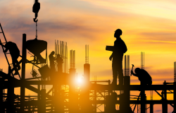 Silhouette of construction workers on site