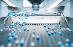 Pharmaceutical capsules on a conveyor belt