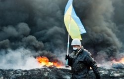 Unknown demonstrator carrying a Ukrainian flag at the Independence square in Kyiv during Euromaidan