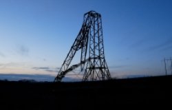 A high-voltage power tower broken as a result of a Russian missile strike against the sky. 